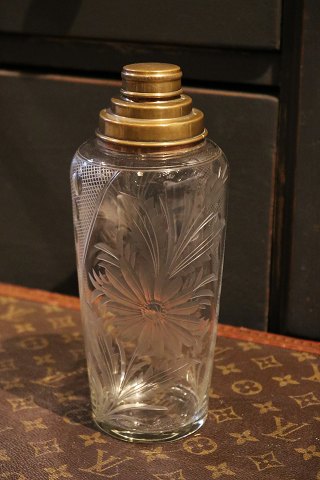 Nice old cocktail shaker in glass with beautiful floral cuts 
and brass top...