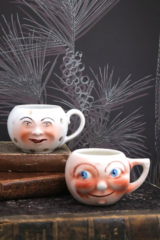 Old faience cups with handles and funny faces from around 1930...