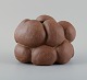 Christina Muff, Danish contemporary ceramicist (b. 1971). Golden brown unglazed stoneware clay vessel with specks. Organically shaped. Clear glaze inside.