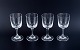 A set of four René Lalique Chenonceaux red wine glasses.Clear mouth-blown crystal glass with facet-cut stem.