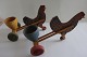 "Chiken pushcart "
2  old/antique chickens, each with a pushcart with a egg cup. 
They are made of wood handmade
There are stamps, but we cannot read them, sorry
Both are in a good condition and they work fine
