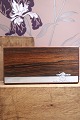 Oblong box in rosewood decorated with silver inlay with a motif of a small 
elephant carrying a tree trunk...