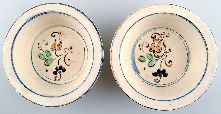 2 Kähler, Denmark, glazed bowls in pottery decorated with flowers.