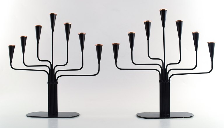 A pair of Ystad metall, Gunnar Ander seven-armed candelabras in metal with brass top. Swedish design.