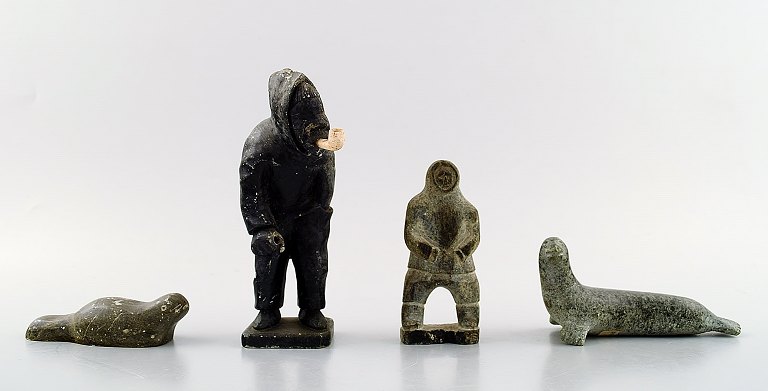 A selection of Greenlandic artefacts, comprising four soapstone figuresKungmiut, East Greenland, one signed "Dinyu.