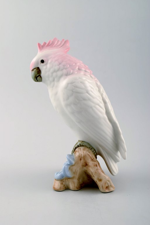 Art Deco Royal Dux parrot on branch, porcelain.