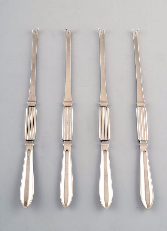 Four Georg Jensen Silver Bernadotte lobster forks.