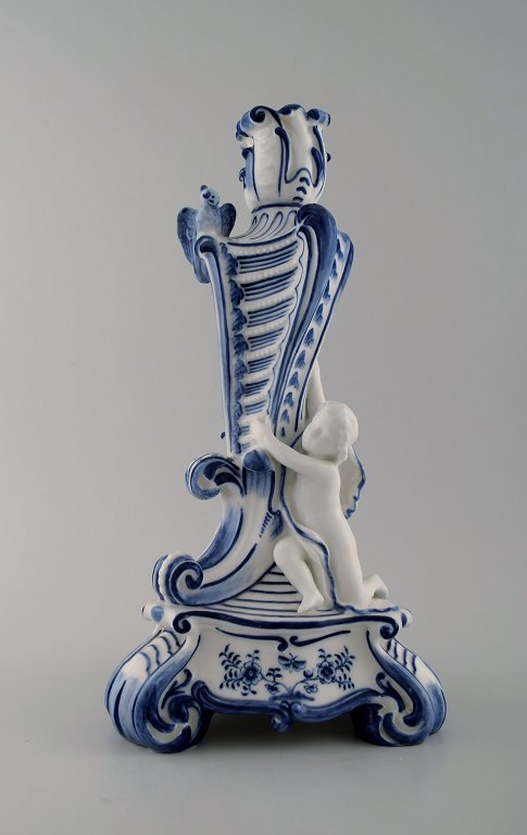Royal Copenhagen. Candlestick of porcelain, Blue Fluted no. 1/13 with bird and fawn sitting on tripod base.