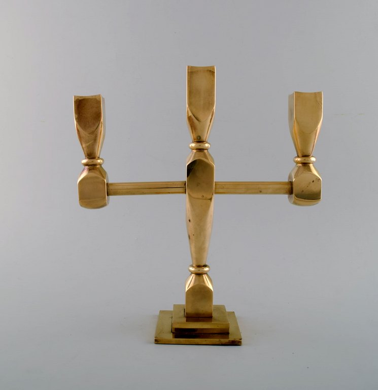 Three-armed candlestick in brass.Scandinavian design.