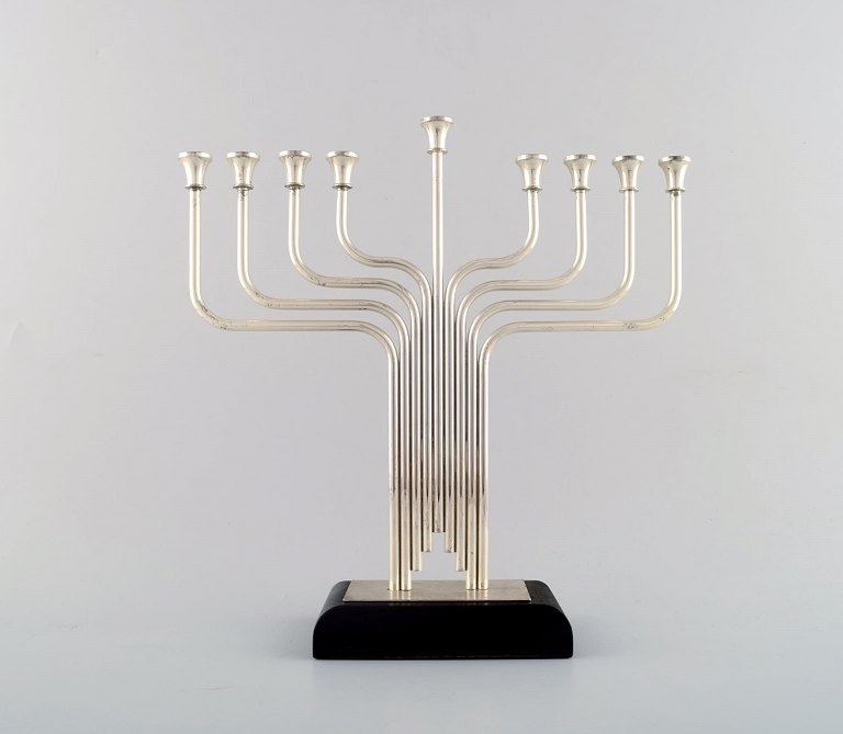 Nine armed candlestick in plated silver on a base of rosewood. Modern style.