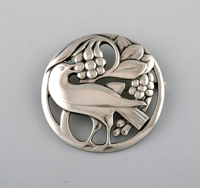 Early Georg Jensen brooch in sterling silver. Design number 53. Bird motif and grapes.