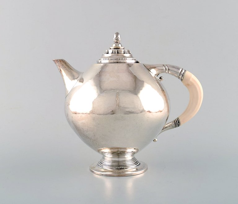 Johan Rohde for Georg Jensen. Rare and early teapot in sterling silver. Round body and ivory handle. Dated 1919.