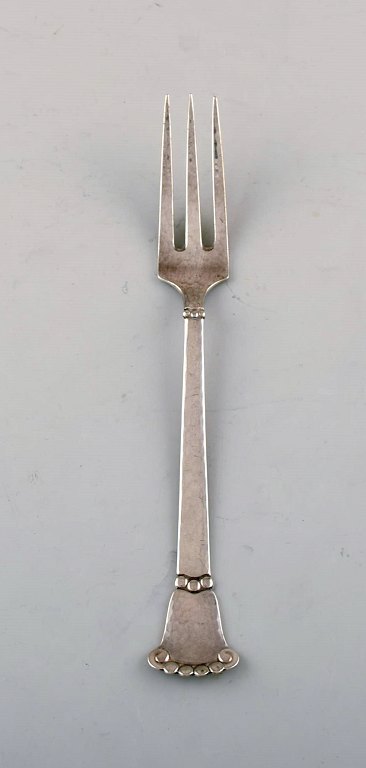 Danish silversmith. "Beaded" dinner fork in hammered silver (830). Dated 1925. Two pieces in stock.