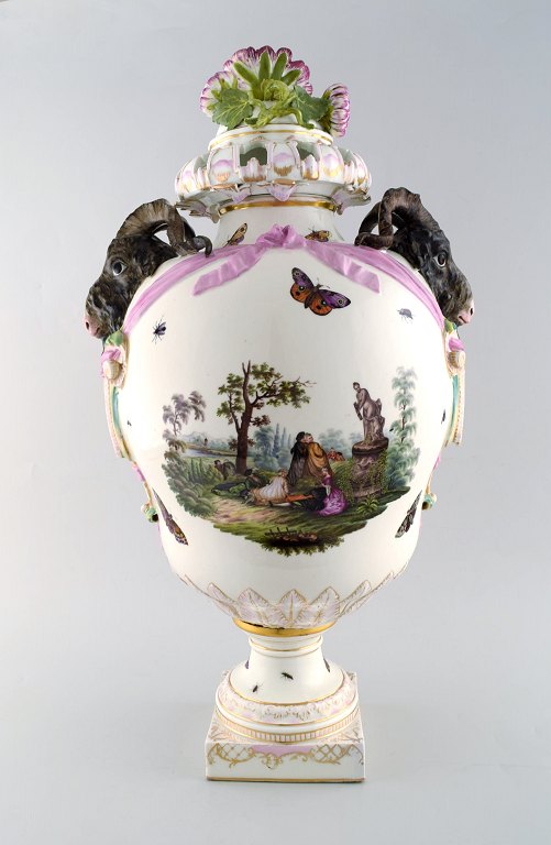 KPM, Berlin. Monumental antique lidded vase in porcelain. Overglaze. Goats and pink flowers in relief and hand painted with butterflies and romantic scenery. Museum quality. 1860