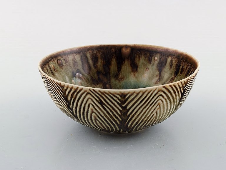 Axel Salto (1889-1961) for Royal Copenhagen. Bowl of glazed stoneware in fluted style. Beautiful glaze in brown and light shades. Model Number 20725. 1930/40
