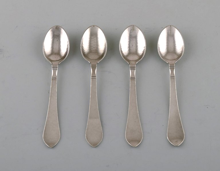 Georg Jensen "Continental" cutlery. Four coffee spoons in hammered sterling silver. Dated 1915-30.