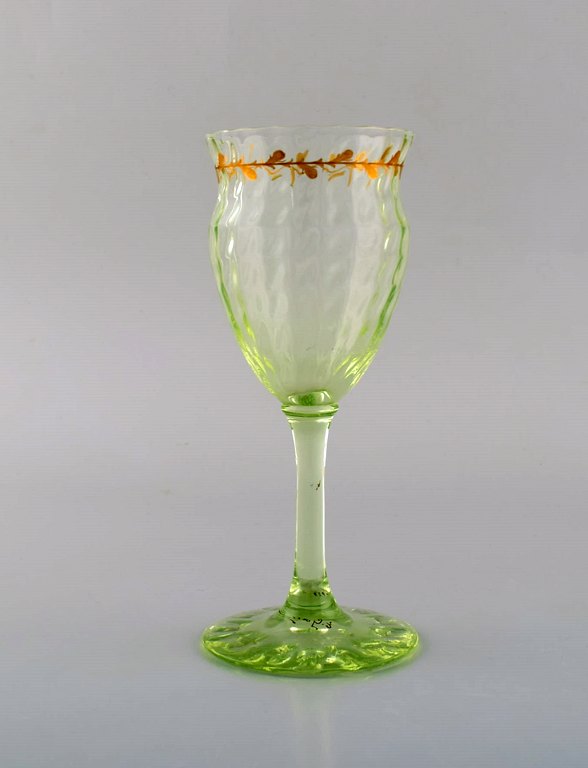 Emile Gallé (1846-1904). Early and rare wine glass in mouth-blown light green art glass with hand-painted gold decorations in the form of leaves. Museum quality, 1870 / 80