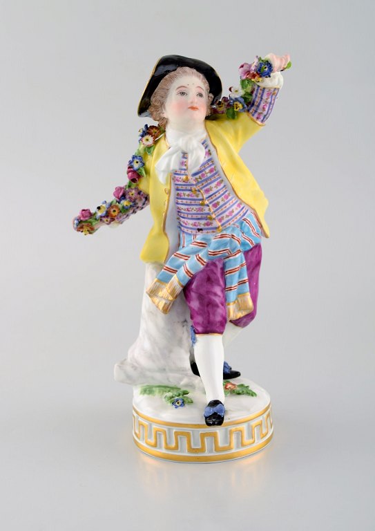 Antique Meissen figurine in hand-painted porcelain. Boy with flowers. Early 20th century.