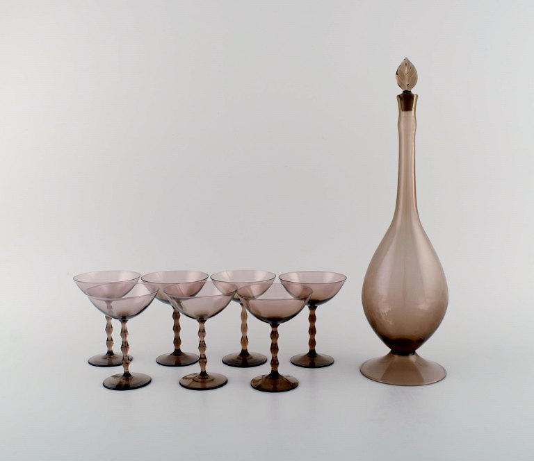 Simon Gate for Orrefors. Art deco liqueur set in smoky mouth-blown art glass. Seven glasses and carafe. 1930