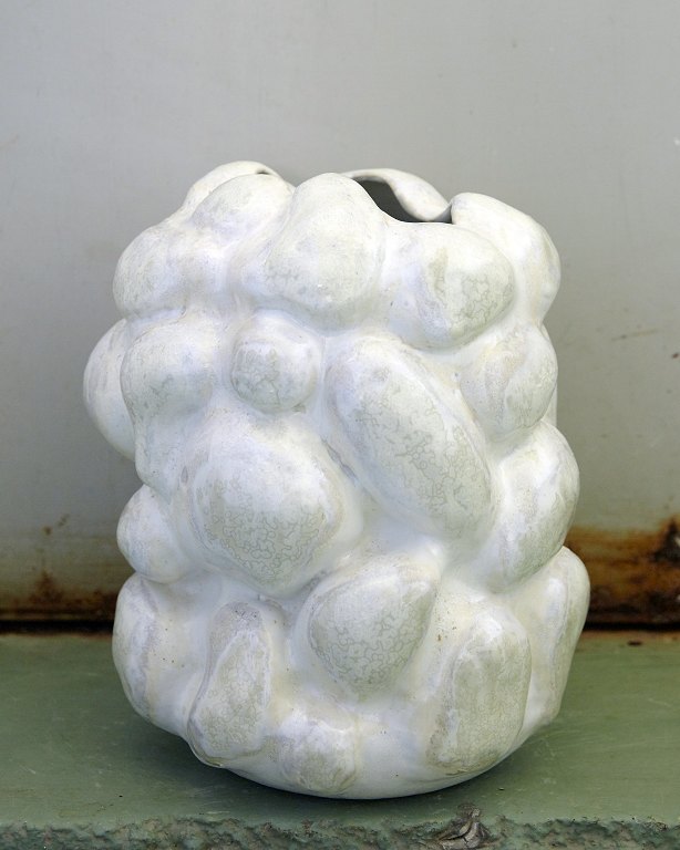 Christina Muff, Danish contemporary ceramist (b. 1971).Medium sized white stoneware sculpture vase with porcelain slip. The vase is hand modeled and has been glazed with white glaze as a base, the bulges are decorated with soft green crystal glaze.