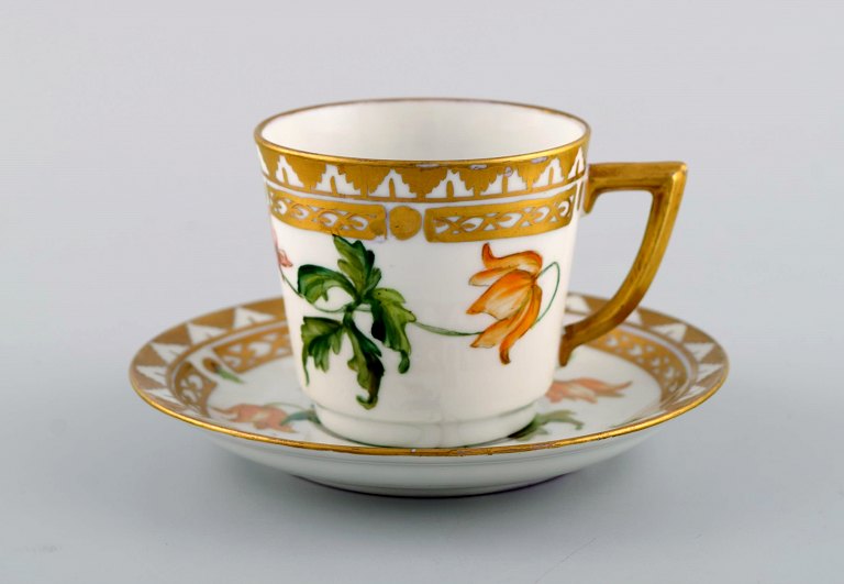 Royal Copenhagen coffee cup with saucer in hand-painted porcelain with gold decoration and flowers. Flora danica style, 1960s.