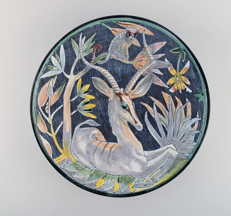 Tilgmans, Sweden. Large unique circular bowl / dish in glazed ceramics with antelope and monkey. Dated 1957.