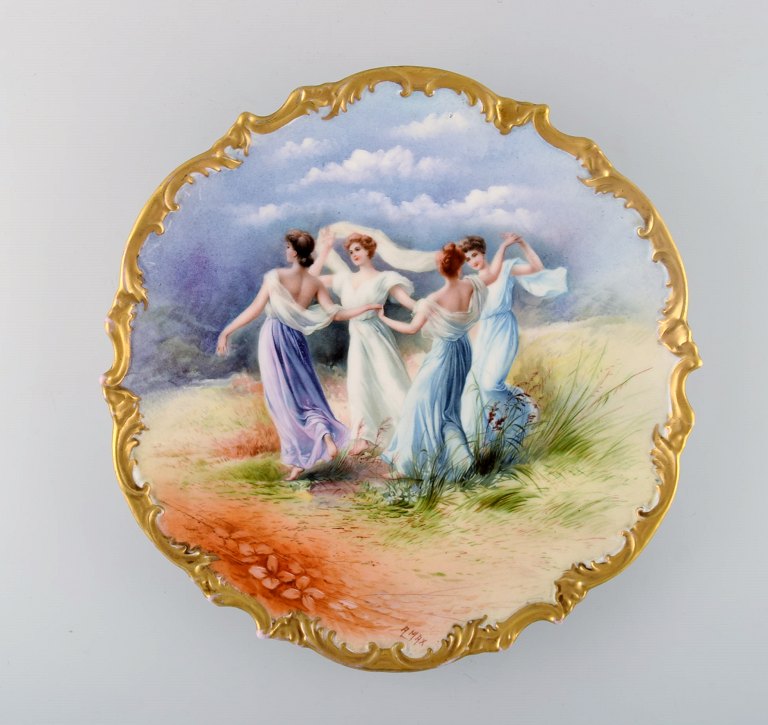 Limoges, France. Large antique dish in hand-painted porcelain decorated with dancing women and gold edge. Early 20th century.