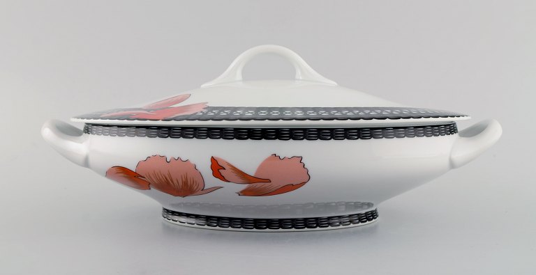 Hermès porcelain lidded tureen decorated with red flowers and black patterned edge. 1980s.