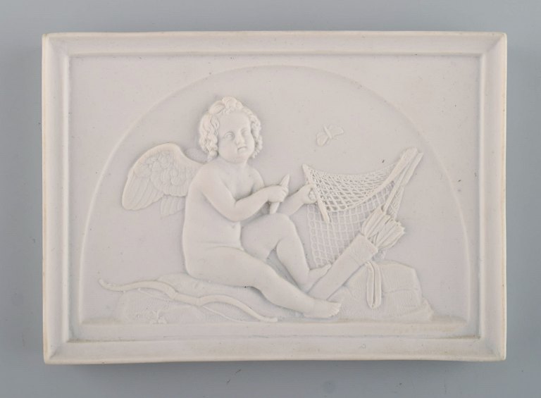Royal Copenhagen after Thorvaldsen. Antique biscuit wall plaque. Amor. Late 19th century.