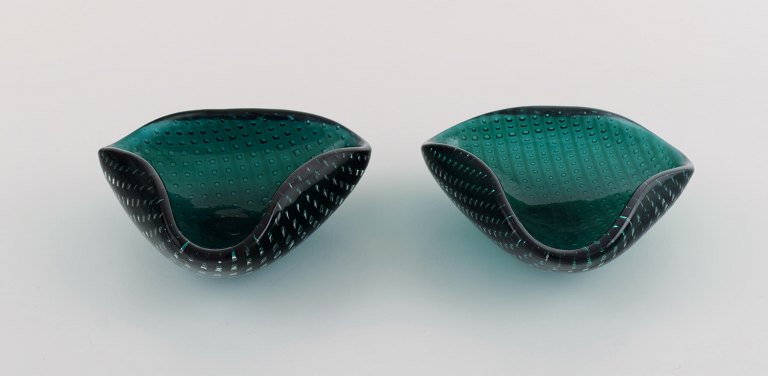 Two Murano bowls in dark green mouth blown art glass with inlaid bubbles. Italian design, 1960s.