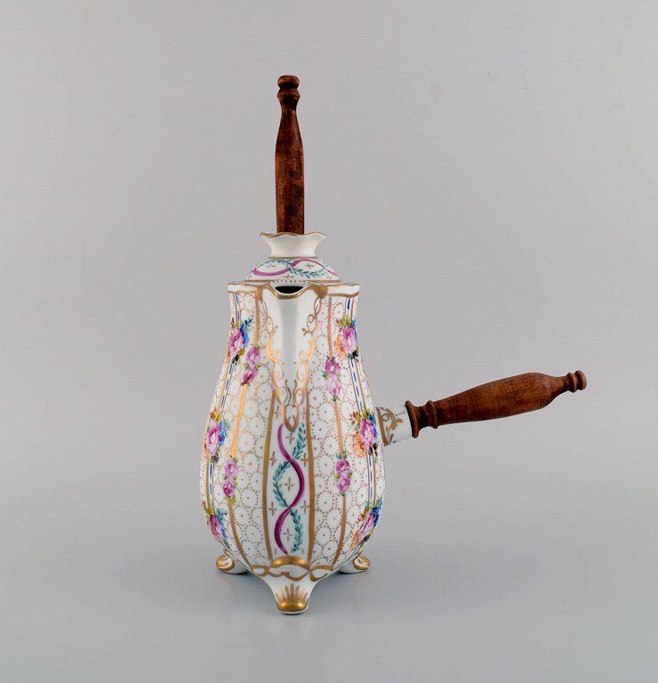 Limoges chocolate pot in hand-painted porcelain with floral and gold decoration. Handle and stirring rod in turned wood. 1920
