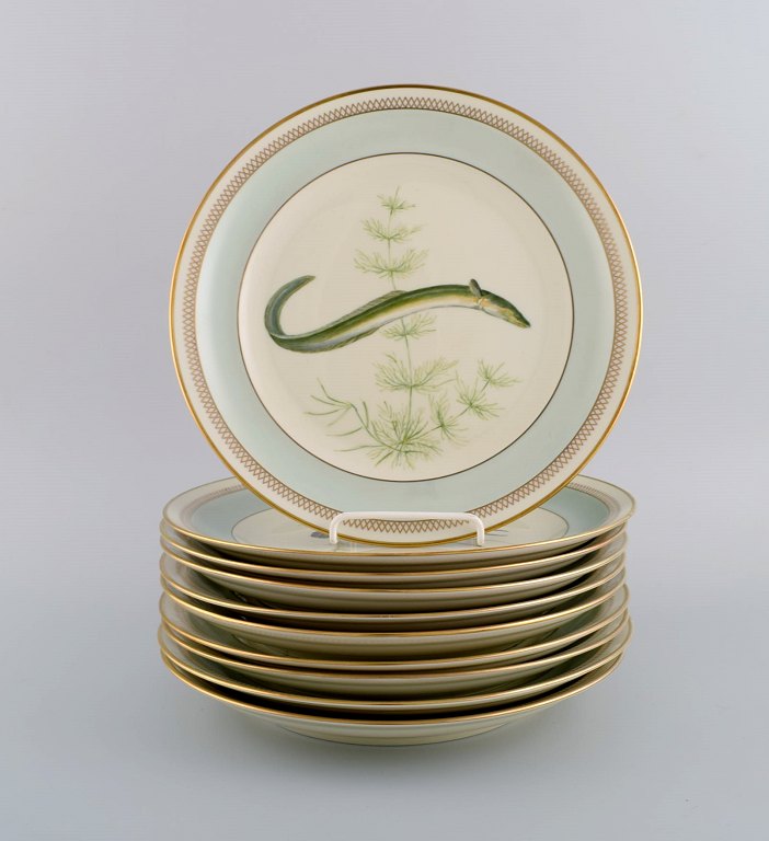 10 Royal Copenhagen porcelain fish plates with hand-painted fish motifs and gold decoration. Dated 1960.