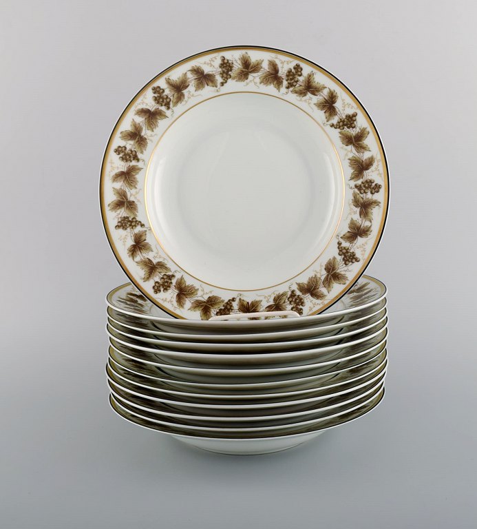 12 Limoges porcelain deep plates with hand-painted grape vines and gold decoration. 1930s / 40s.