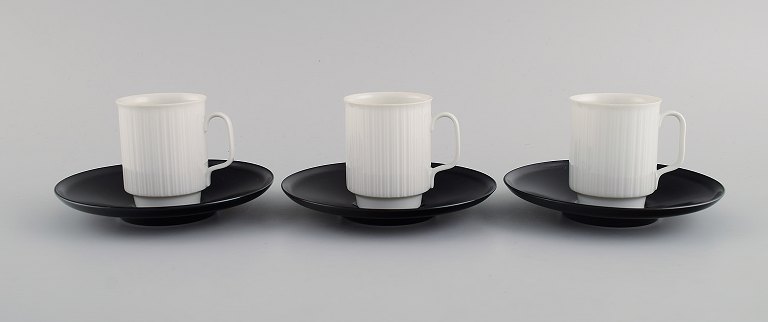 Tapio Wirkkala for Rosenthal. Three porcelain noire mocha cups with saucers in black and white fluted porcelain. 1980