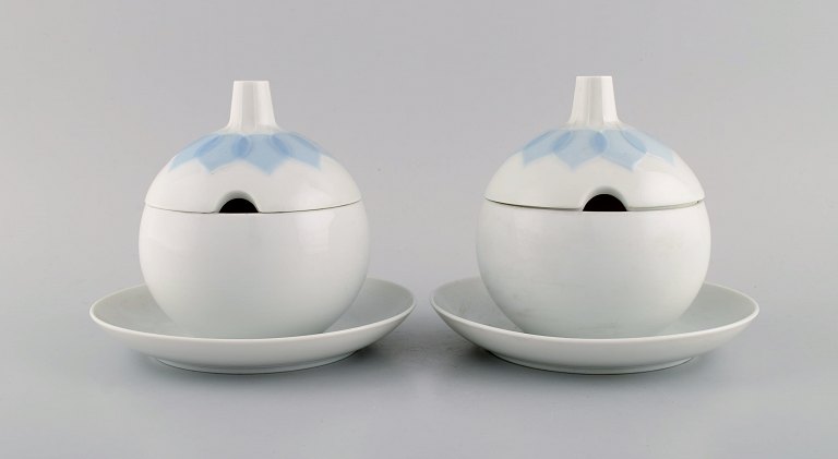 Bjørn Wiinblad for Rosenthal. Two Lotus sauce boats in porcelain decorated with light blue lotus leaves. 1980s.