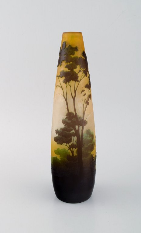 Antique Emile Gallé vase in yellow frosted and dark art glass carved in the form of a park landscape with trees and a bridge. Rare model. Early 20th century.