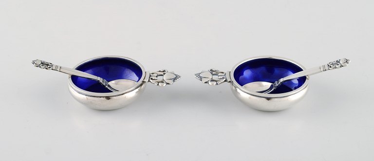 Johan Rohde for Georg Jensen. Two Acorn salt vessels in sterling silver with royal blue enamel and accompanying spoons. Design 62.