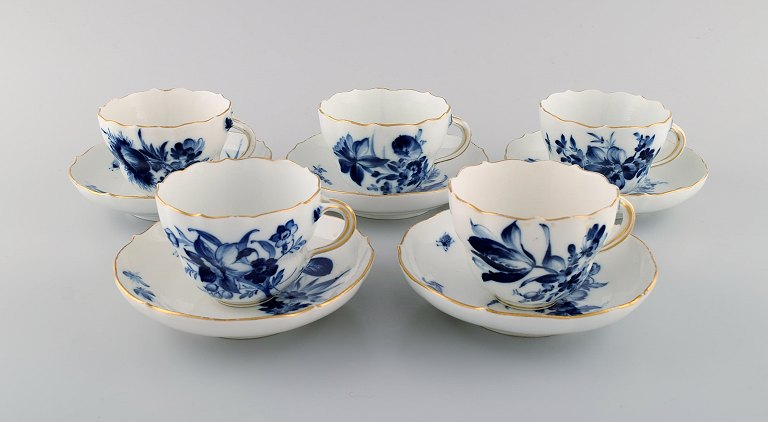 Five antique Meissen coffee cups with saucers in porcelain with hand-painted flowers, insects and gold edge. Early 20th century.