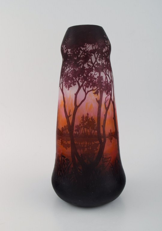 Daum Nancy, France. Large antique vase in mouth blown art glass decorated with lake landscape and trees. Approx. 1910.