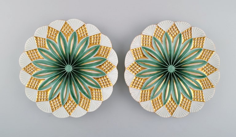 Two antique Meissen plates in hand-painted porcelain. Light green flowers and gold decoration. Early 20th century.