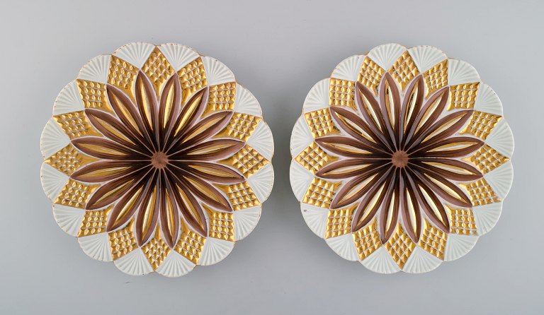 Two antique Meissen plates in hand-painted porcelain. Light brown flowers and gold decoration. Early 20th century.