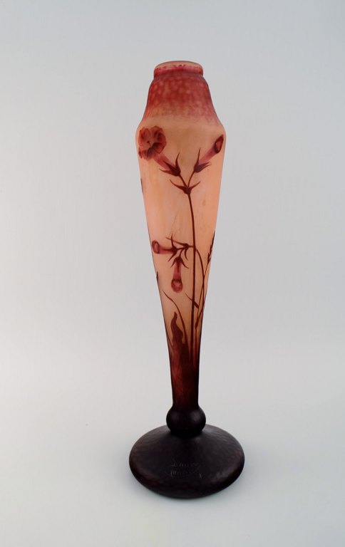 Daum Nancy, France. Large "Tobacco flowers" multilayer glass vase with an etched decor of red flowers on a yellow-orange and pink background. Early 20th century. Museum quality.