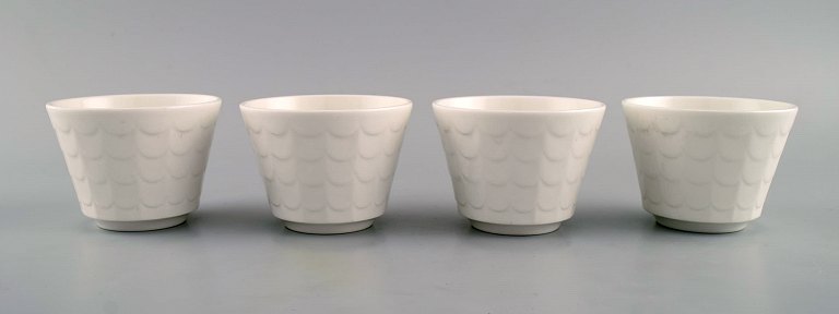 Wilhelm Kåge for Gustavsberg. Four flower pot covers in porcelain. Swedish design, 1960s.