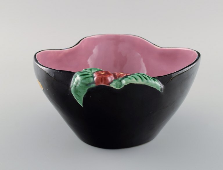 French studio ceramicist. Bowl in glazed ceramics modeled with flowers. Pink interior glaze. Late 20th century.
