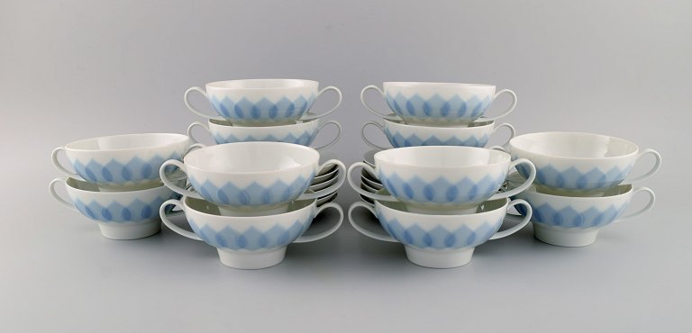 Bjørn Wiinblad for Rosenthal. Twelve Lotus porcelain bouillon cups with saucers decorated with light blue lotus leaves. 1980s.