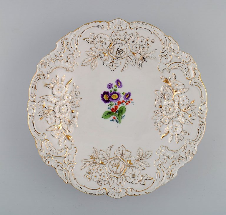 Antique Meissen porcelain bowl with hand-painted flowers and gold decoration. Early 20th century.