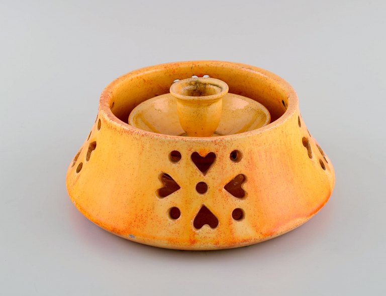 Kähler, Denmark. Candlestick with heater in glazed stoneware. Beautiful orange uranium glaze. Mid-20th century.