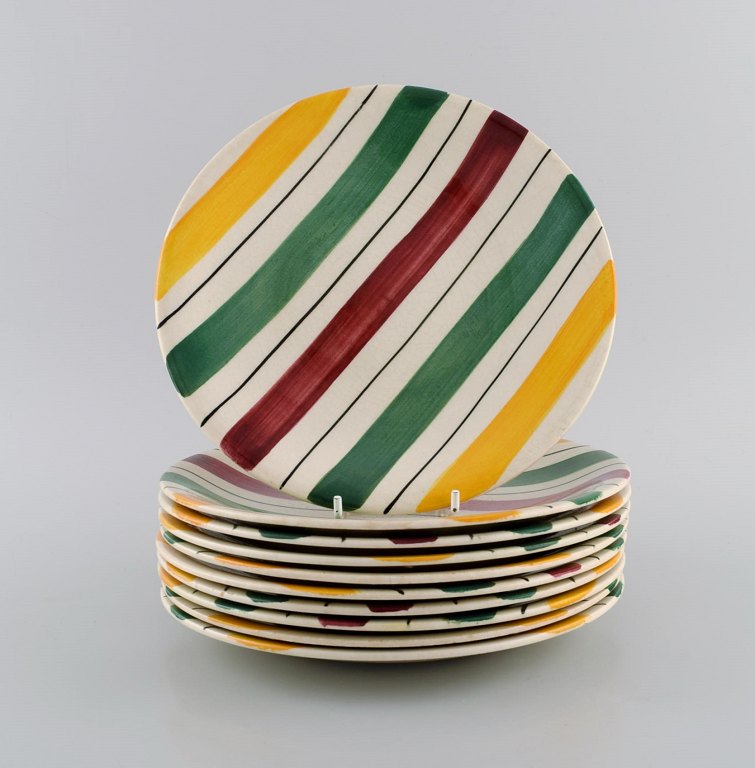 Longchamp, France. 10 plates in glazed faience with hand-painted striped decoration. Mid-20th century.