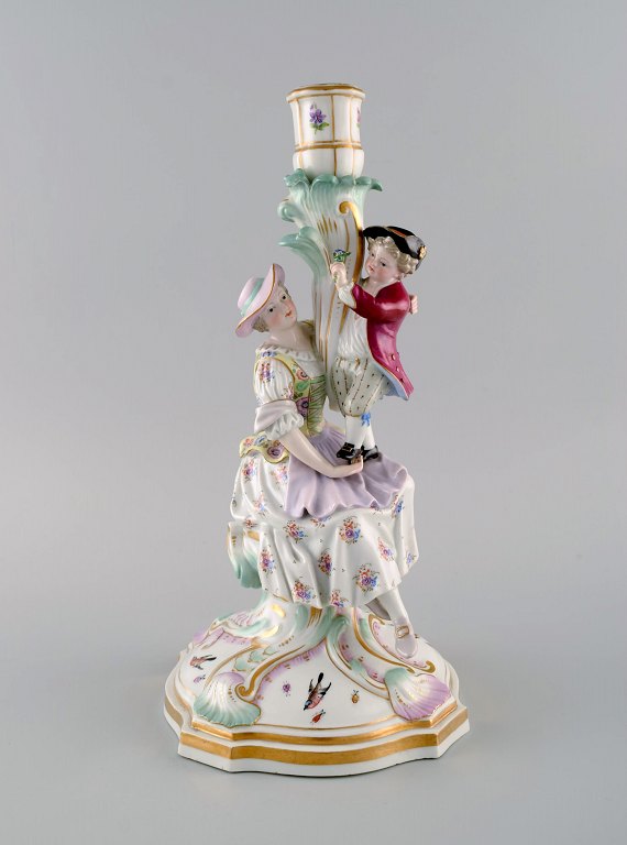 Antique Meissen candlestick in hand-painted porcelain. Mother and boy with flowers. Late 19th century.