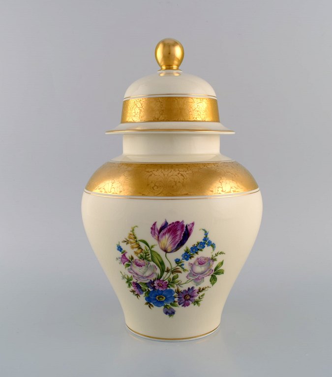 Large Rosenthal lidded vase in cream-colored porcelain with hand-painted flowers and gold leaf decoration. Mid-20th century.